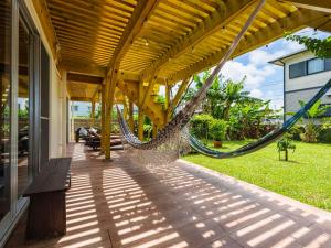 a hammock on the porch of a house at Panorama in Yomitan
