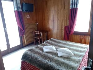 Postel nebo postele na pokoji v ubytování Hôtel Le Mont Jorat