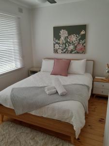 a bedroom with a large bed with two towels on it at Para House, Tanunda. In the heart of The Barossa Valley!. in Tanunda