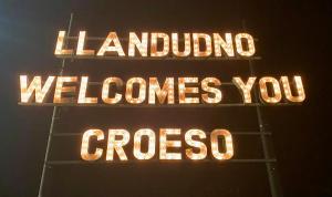 a neon sign that says honolulu welcomesavascript crossaho at Llandudno Boutique style seaside retreat with stunning views in Llandrillo-yn-Rhôs