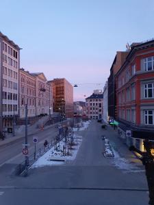 an empty street in a city with buildings at Bright and charming apartment from 1878 with view to the new National Museum in Oslo in Oslo