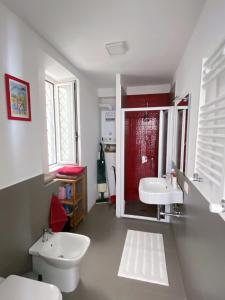 a bathroom with a white toilet and a sink at Casa Balo Pozzuoli in Pozzuoli