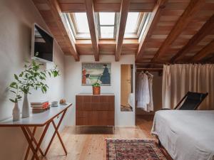 a bedroom with a bed and a desk and a window at Masseria Scannaturco in Marina di Pisticci