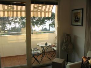 a room with a balcony with a table and a window at Apartment Oliva with sea view in Fažana