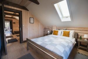 a bedroom with a bed and a skylight at CHATA POD PRZEHYBĄ in Stary Sącz