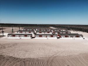 a group of houses in the middle of the desert at Oasis Lodge in Big Lake
