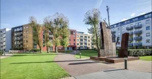 a park with a sculpture in front of some buildings at Apartment Central London in London