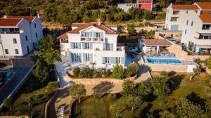 an aerial view of a house with a swimming pool at Rooms Salvia in Cres