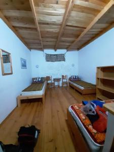 Cette chambre comprend deux lits, une table et des chaises. dans l'établissement Eldos-Ata Eco Hotel, à Tossor