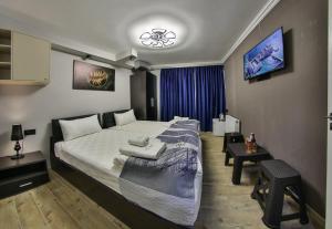a hotel room with a large bed and a table at La Casa Hotel Yerevan in Yerevan +46 photos