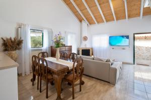 a living room with a table and a couch at Vive Mar Paxos in Gaios