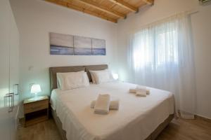 Postel nebo postele na pokoji v ubytování Vive Mar Paxos