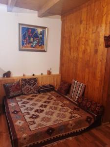 a bedroom with a large bed with a rug on it at East in Baku