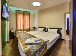 a bedroom with two beds in a room at La Casa Hotel Yerevan in Yerevan
