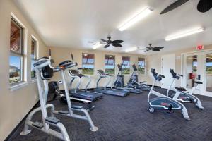 a gym with several treadmills and elliptical machines at Pili Mai 7M in Koloa