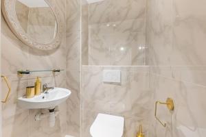 a white bathroom with a sink and a mirror at Urban style 3-bedroom apartment in Montreux