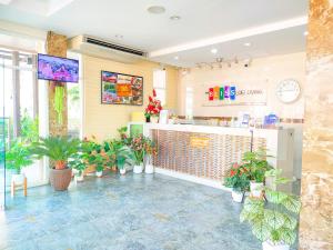 a restaurant with potted plants and a counter at The Bliss Loei Living in Loei