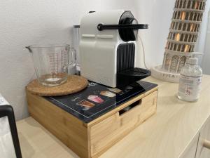 a blender sitting on top of a wooden stand on a counter at Varese Apartment in Varese