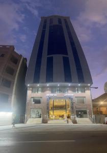 a tall building with a person walking in front of it at فندق سمى الخير in Makkah +9 photos