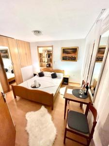 a bedroom with a large bed and a table at Studios Magnolia in Trogir