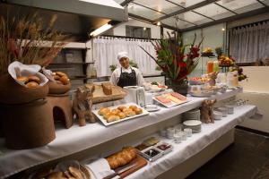 a chef standing in front of a buffet of food at Hotel Encantada Casa Boutique Spa in Cusco +36 photos