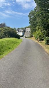 an empty road in a residential neighborhood with houses at JS Holidays The Westmorland Lagganhouse in Ballantrae