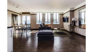a living room with a couch and a table at Pass the Keys Spacious Luxury Apartment in the Heart of London in London