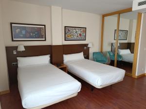 Postel nebo postele na pokoji v ubytování Hotel Palacio Congresos