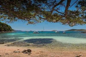 a view of a beach with boats in the water at Apartman Milica in Vrgada