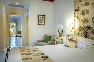 Postel nebo postele na pokoji v ubytování Palazzo Belmonte