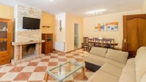 a living room with a couch and a fireplace at Villa la Quinta Priego de Córdoba by Ruralidays in Priego de Córdoba