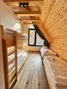 a large room with three bunk beds in it at Chata Demian in Demanovska Dolina