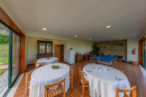 a room with two tables and a pool table at Casa de Valdemar in Felgueiras