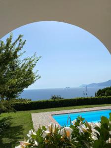 uitzicht op een zwembad met de oceaan op de achtergrond bij Villa Giulia in Praiano