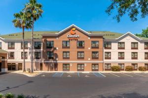 a rendering of a courtyard hotel with a parking lot at Comfort Suites Tallahassee Downtown in Tallahassee