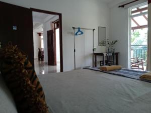a bedroom with a large bed in a room at Lake Life Villa in Ambalangoda