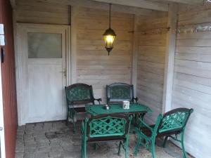 a table and chairs on the back porch of a house at Schwedenhaus in Mönkebude