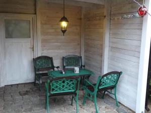 a table and chairs on the back porch of a house at Schwedenhaus in Mönkebude