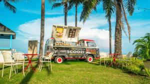 an ice cream truck parked next to chairs and palm trees at Radisson Resort & Spa Hua Hin in Cha Am