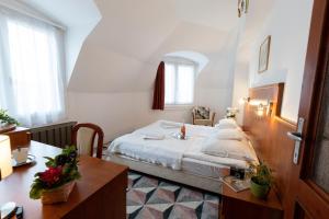 a hotel room with a bed and a desk at HELIOS Hotel Apartments in Budapest