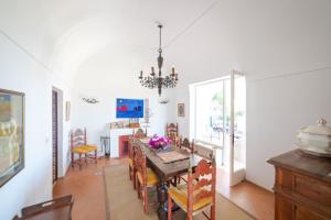 a dining room with a table and chairs at Villa Le Tuie by Elite Villas in Capri