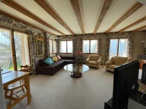 a living room with a couch and a table at Le Grand Duc in Chateau-d'Oex