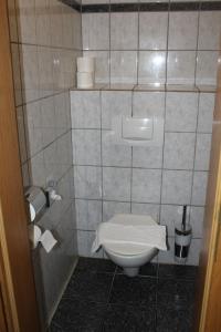 a bathroom with a toilet with a towel on it at Rasthaus Hotel Schackendorf in Schackendorf