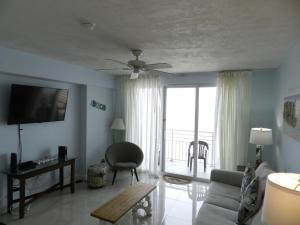 a living room with a couch and a ceiling fan at 1 BR Resort Condo Direct Oceanfront Wyndham Ocean Walk - Daytona Funland 1307 in Daytona Beach
