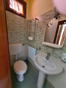 a bathroom with a toilet and a sink at CASASALENTINA in Acquarica del Capo