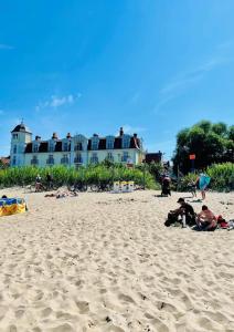 a group of people sitting on a sandy beach at Hotel Lival in Gdańsk