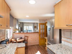 a kitchen with a table and a yellow door at Holiday Home La Victoria by Interhome in Palafrugell +26 photos