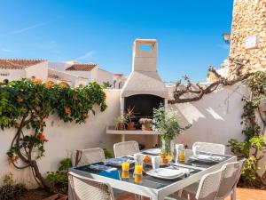 einen Tisch und Stühle auf einer Terrasse mit einem Pizzaofen in der Unterkunft Apartment Capuchinos San Juan de Capistrano by Interhome in Nerja