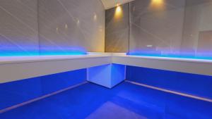 a bathroom with blue lights in a room at Azur en Ardenne in Durbuy