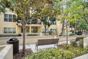 a park with benches and trees in front of a building at Santa Clara 1BR w Gym Pool WD SFO-641 in Santa Clara